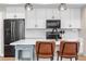 Well-equipped kitchen with white cabinets, stainless steel appliances, and an inviting island with seating at 9768 E 62Nd Dr, Denver, CO 80238