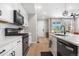 Bright, modern kitchen featuring white cabinets, stainless steel appliances, and an open layout at 9768 E 62Nd Dr, Denver, CO 80238
