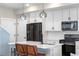 Modern kitchen with white cabinets, stainless steel appliances, a sleek island, and pendant lighting at 9768 E 62Nd Dr, Denver, CO 80238