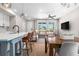 Open concept living space featuring a modern kitchen island, dining area, and comfortable living room at 9768 E 62Nd Dr, Denver, CO 80238