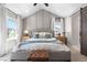 Serene main bedroom featuring high ceilings, ample natural light, and elegant decor at 9768 E 62Nd Dr, Denver, CO 80238