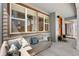 Inviting front porch featuring a comfortable outdoor sofa, stylish pillows, and a welcoming entrance at 9768 E 62Nd Dr, Denver, CO 80238