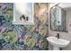Stylish powder room featuring floral wallpaper, modern fixtures, and a pedestal sink at 9768 E 62Nd Dr, Denver, CO 80238