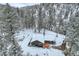 Charming cabin nestled in a snow-covered forest with beautiful mountain views at 30570 Highway 72, Golden, CO 80403