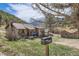 Charming log cabin-style home nestled in a serene, wooded landscape with a classic mailbox at 30570 Highway 72, Golden, CO 80403