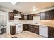Kitchen with white appliances and dark cabinets at 30570 Highway 72, Golden, CO 80403
