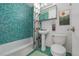 Unique bathroom features vibrant blue-green tiling and modern fixtures at 1245 Columbine St # 306, Denver, CO 80206
