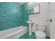 Unique bathroom with a retro, blue-green tile surround at 1245 Columbine St # 306, Denver, CO 80206