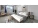 Cozy bedroom with a large window and stylish furnishings at 1245 Columbine St # 306, Denver, CO 80206
