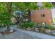 Brick apartment building showcasing well-maintained landscaping and a walkway leading to the entrance at 1245 Columbine St # 306, Denver, CO 80206