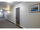 Hallway with carpet, light-colored walls, sconce lighting, and framed art at 1245 Columbine St # 306, Denver, CO 80206