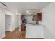 Cozy kitchen featuring wooden cabinets, stainless steel appliances, and an open view to living space at 1245 Columbine St # 306, Denver, CO 80206