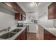 Open concept kitchen with wooden floors, stainless steel appliances, white walls, and a dining area at 1245 Columbine St # 306, Denver, CO 80206