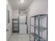 Laundry room with washer, dryer, shelves, and tiled flooring at 1245 Columbine St # 306, Denver, CO 80206