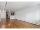 Open-concept living area with hardwood floors connecting to the kitchen at 1245 Columbine St # 306, Denver, CO 80206