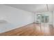 Bright living room with hardwood floors, white walls, and sliding glass doors at 1245 Columbine St # 306, Denver, CO 80206