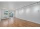 Spacious living room featuring hardwood floors, white walls, and sliding glass doors to a patio at 1245 Columbine St # 306, Denver, CO 80206