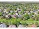 An aerial view showcases the neighborhood, with mature trees and well-maintained lawns, indicating a serene setting at 16342 Parkside Dr, Parker, CO 80134