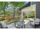 Backyard patio featuring an outdoor dining and seating area with greenery at 16342 Parkside Dr, Parker, CO 80134