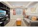 Finished basement with a custom bookshelf, TV, sofa and decorative wall art at 16342 Parkside Dr, Parker, CO 80134