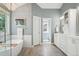 Luxurious bathroom with a freestanding tub, tiled floors, and elegant chandelier at 16342 Parkside Dr, Parker, CO 80134