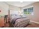 Bright bedroom featuring a large window, striped bedding and carpeted floor at 16342 Parkside Dr, Parker, CO 80134