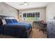 Cozy bedroom with rustic accent wall, large window and dark furniture set at 16342 Parkside Dr, Parker, CO 80134