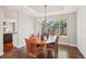 Elegant dining room with hardwood floors, modern chandelier, a large window, and stylish decor at 16342 Parkside Dr, Parker, CO 80134