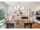 Dining room featuring a chandelier and space for six, overlooking the backyard, with the kitchen visible at 16342 Parkside Dr, Parker, CO 80134
