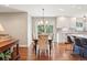 Well-lit dining room with hardwood floors, a chandelier, and a table set for four, adjacent to the kitchen at 16342 Parkside Dr, Parker, CO 80134