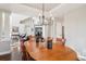 Open dining room with hardwood floors, elegant lighting, views to the front door, and a bright atmosphere at 16342 Parkside Dr, Parker, CO 80134
