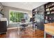 Home office with a large window, built-in shelving, and hardwood floors, perfect for remote work at 16342 Parkside Dr, Parker, CO 80134