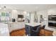 Updated kitchen with white cabinets, stainless steel appliances, quartz countertops, and a dark island at 16342 Parkside Dr, Parker, CO 80134