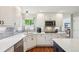 Bright and modern kitchen featuring white cabinets, stainless steel appliances, and an island with seating at 16342 Parkside Dr, Parker, CO 80134