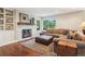 Relaxing living room with a stone fireplace, hardwood floors, a plush sectional, and natural light at 16342 Parkside Dr, Parker, CO 80134