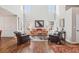 Spacious living room with high ceilings, hardwood floors, large windows, and cozy seating arrangements at 16342 Parkside Dr, Parker, CO 80134