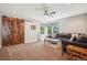 Inviting living room with a sliding barn door, recessed lights and a comfortable sectional at 16342 Parkside Dr, Parker, CO 80134