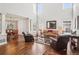 Bright, airy living room featuring soaring ceilings, hardwood floors, many windows, and stylish furnishings at 16342 Parkside Dr, Parker, CO 80134