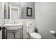 Stylish powder room features a pedestal sink, grey walls, and tiled backsplash at 16342 Parkside Dr, Parker, CO 80134