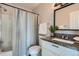 Bathroom features a shower-tub combo, granite counters, and vanity mirror at 499 Wright St # 308, Lakewood, CO 80228