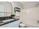 Full bathroom features a shower-tub combo, granite counters, and updated fixtures at 499 Wright St # 308, Lakewood, CO 80228