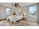 Bright bedroom features a cozy bed, natural light, and ceiling fan at 499 Wright St # 308, Lakewood, CO 80228