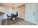 Dining area with a modern table and chairs, barn door detail at 499 Wright St # 308, Lakewood, CO 80228