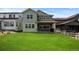 Expansive backyard with lush green grass and a covered patio, ideal for outdoor enjoyment at 8550 Cheraw St, Littleton, CO 80125