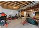 Unfinished basement with exposed ceiling beams offering great potential and storage space at 8550 Cheraw St, Littleton, CO 80125
