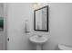 Clean, minimalist powder room with a pedestal sink at 8550 Cheraw St, Littleton, CO 80125