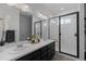 Bathroom features double sink vanity and a glass enclosed shower at 8550 Cheraw St, Littleton, CO 80125