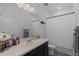Bathroom features white counter, single sink, and white shower curtain at 8550 Cheraw St, Littleton, CO 80125