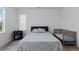 Bedroom with carpet, a grey bed with headboard, and next to a crib at 8550 Cheraw St, Littleton, CO 80125