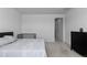 Bright bedroom with black dresser and view to door at 8550 Cheraw St, Littleton, CO 80125